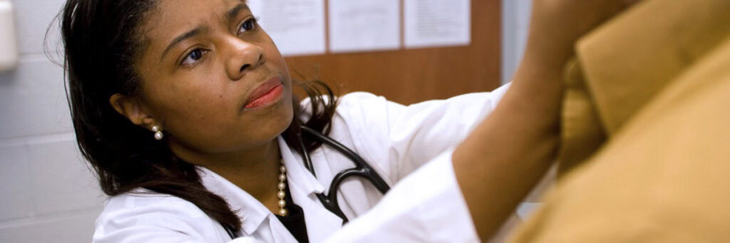 Close-up of nurse reaching up and helping patient.