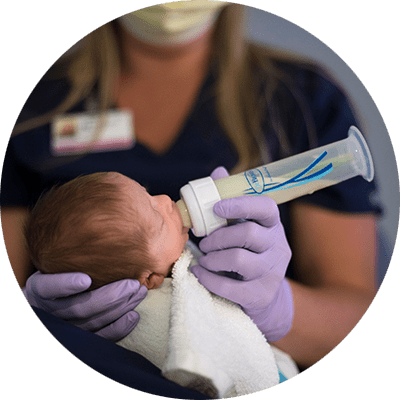 Nurse bottle-feeding new born